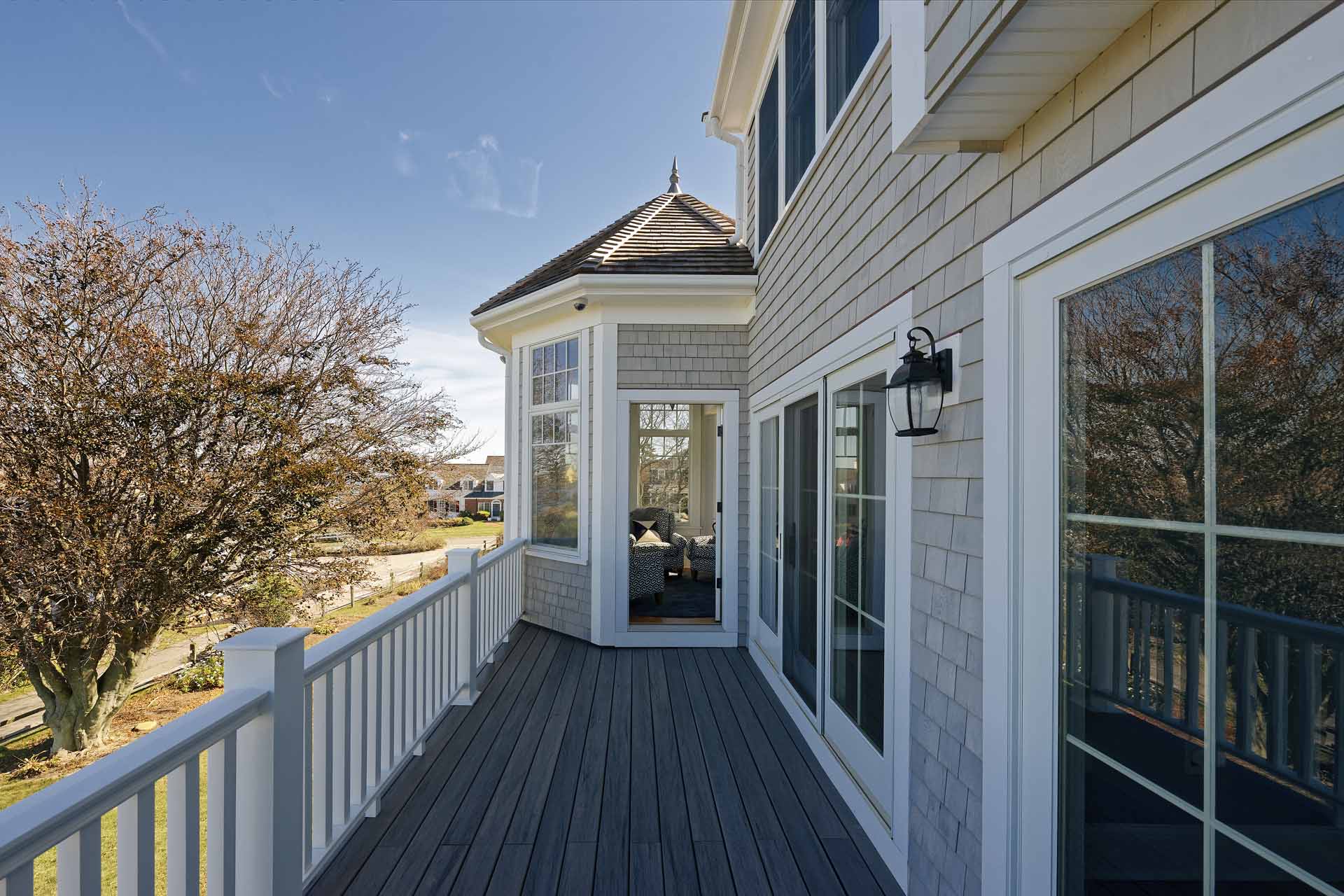 The rear deck, wrapping around a cupola-topped bay window with unobstructed harbor views.